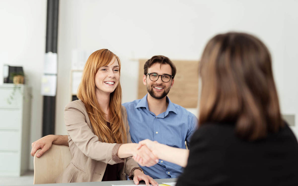 two people shaking hands at a meeting