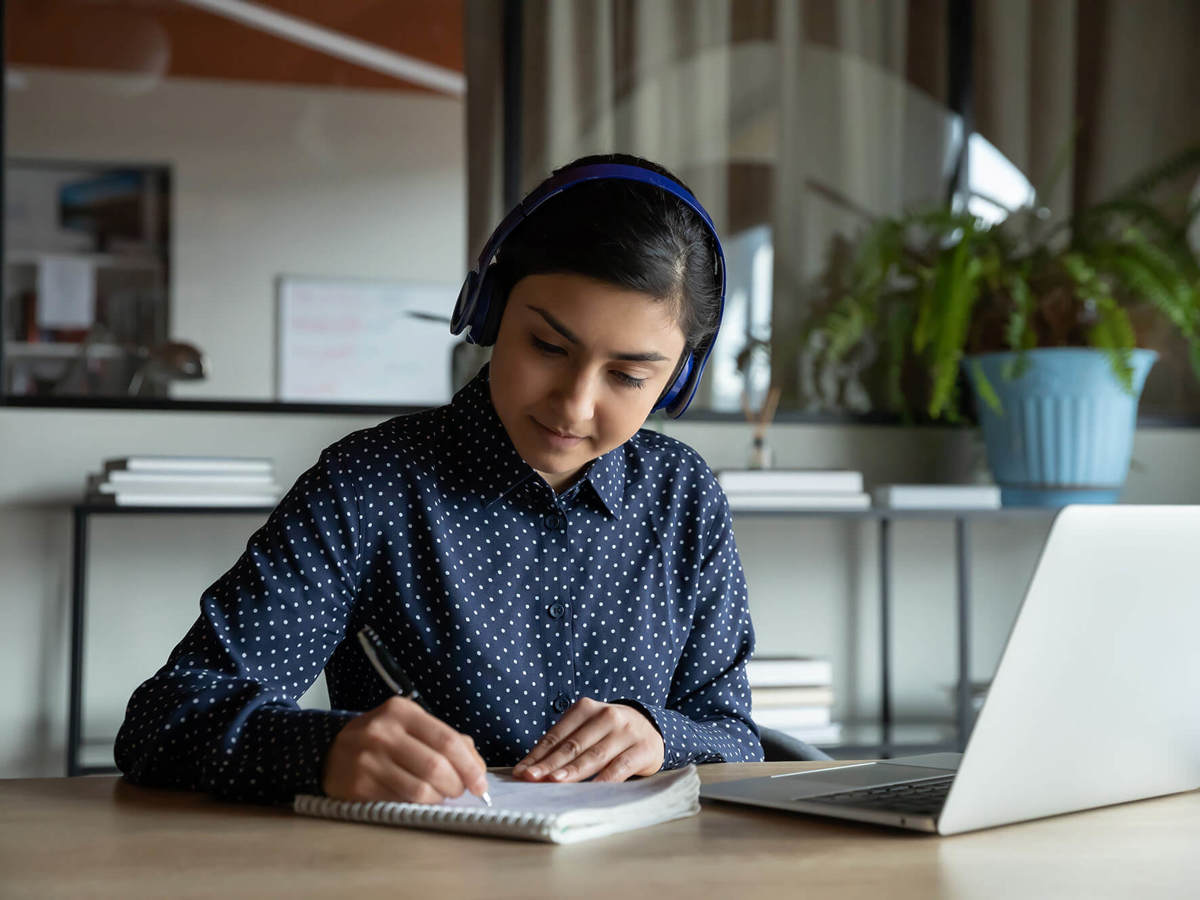 people woman writing notes off her laptop
