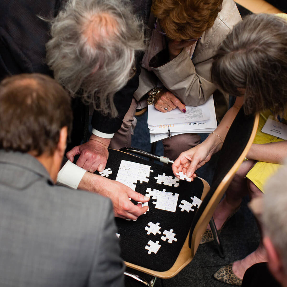 people solving a puzzle together