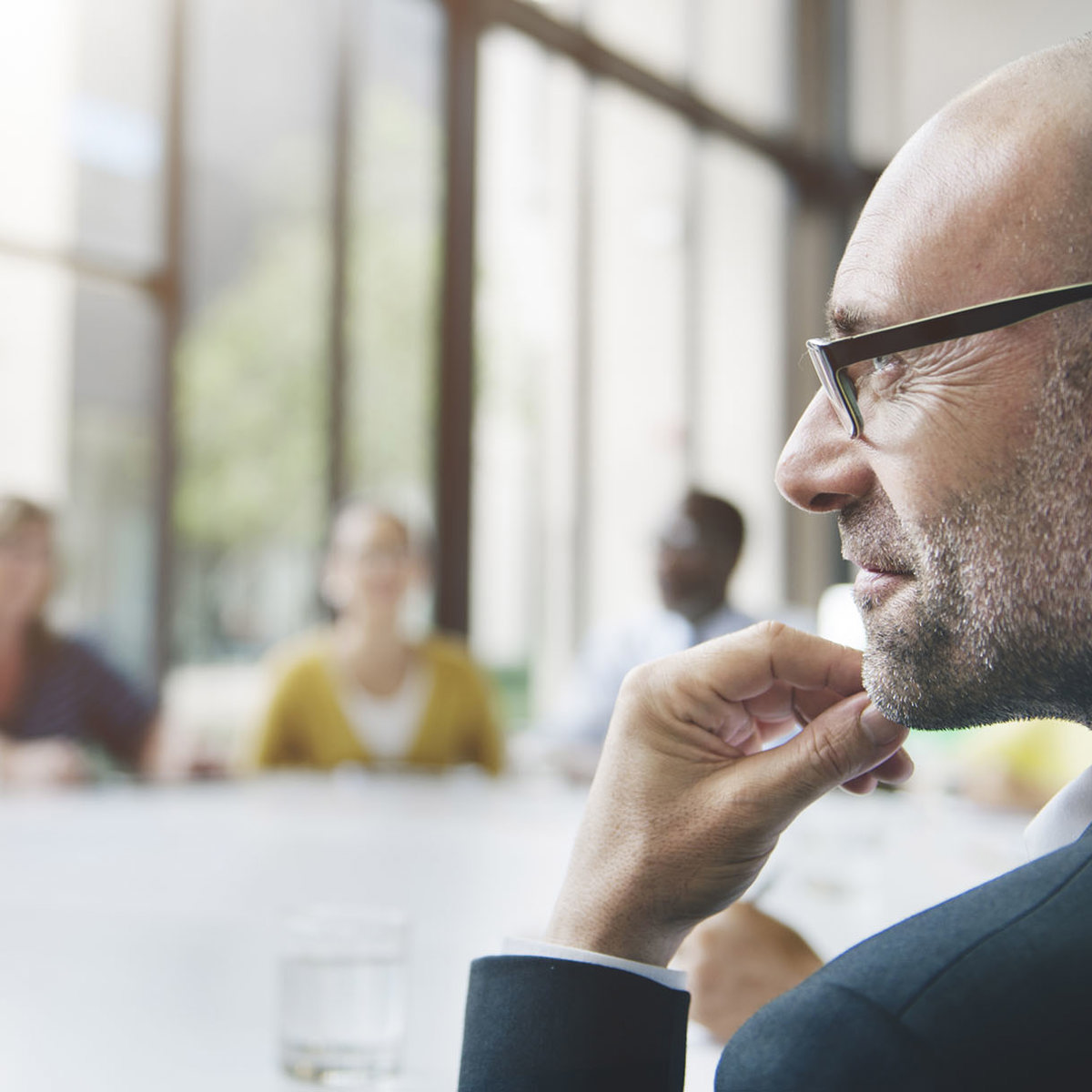 training man thinking at round table