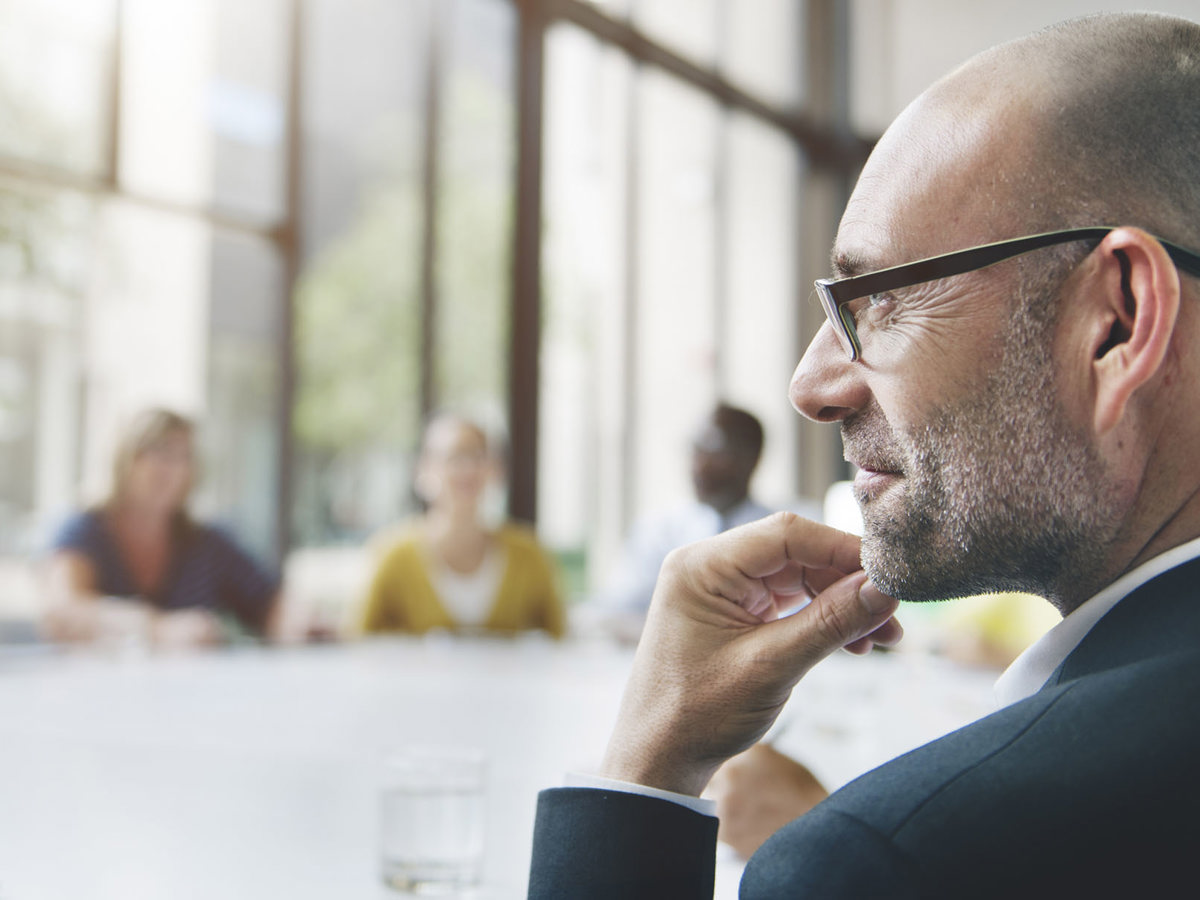 training man thinking at round table