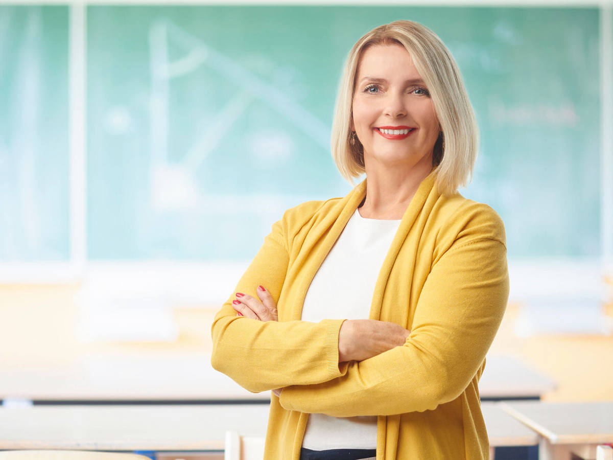people woman smiling into the camera in a classroom
