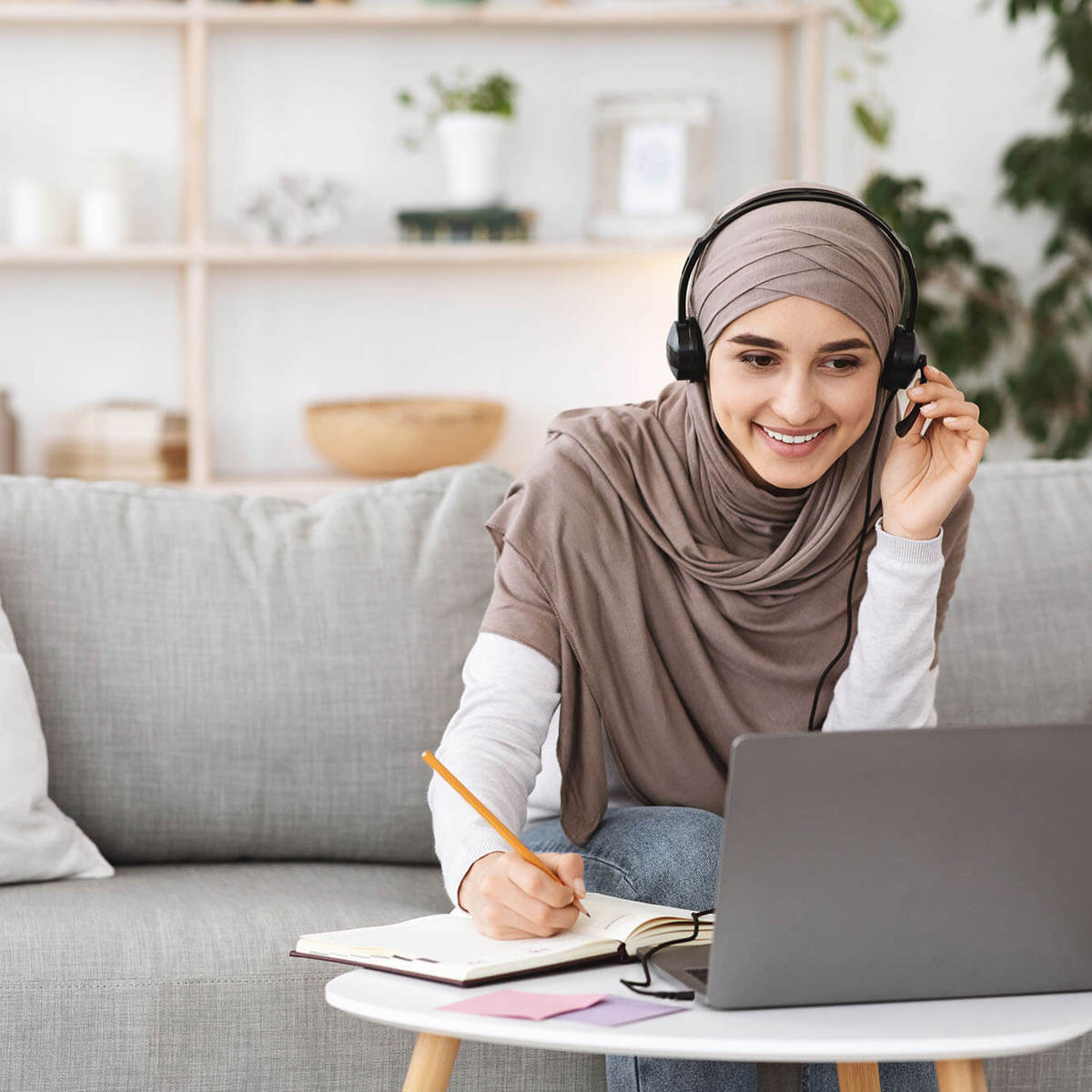 people woman using her laptop writing notes