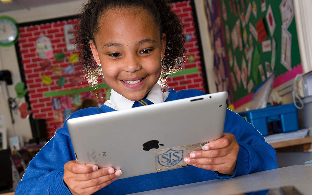 Pupils-learning young pupil using a tablet in class