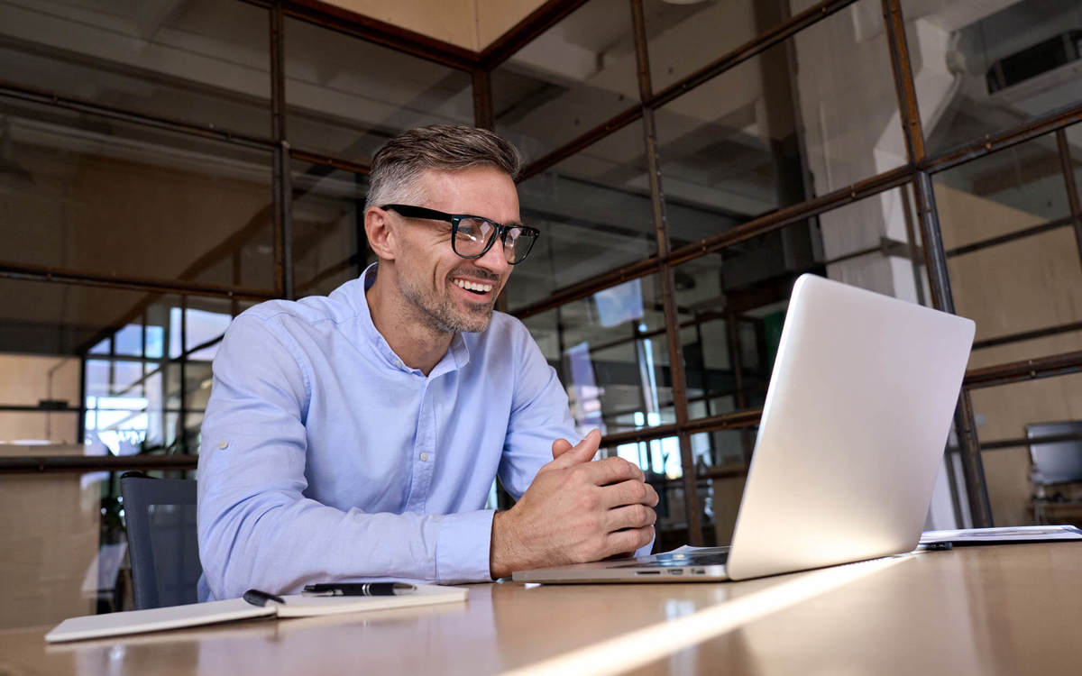 people man smiling at his laptop